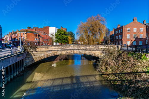 A view up the River Welland towards the Church Street bridge in the centre of Spalding, Lincolnshire on a bright sunny day