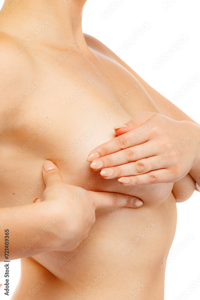 Woman examining her breast isolated on white background
