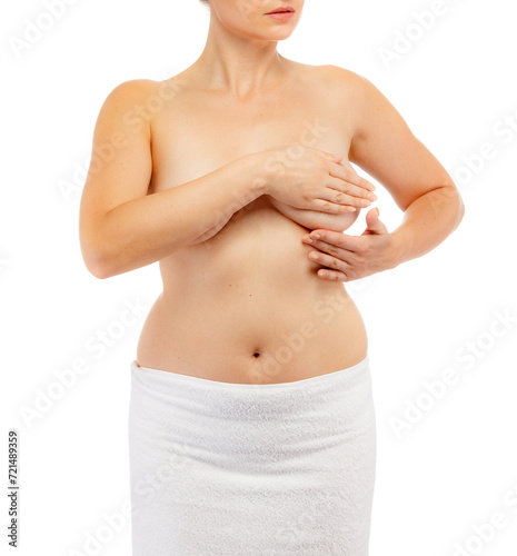 Woman examining her breast isolated on white background
