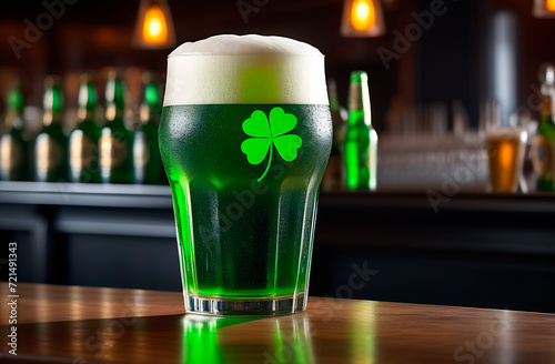 Glass of green foamy beer decorated with clover leaf, beer pub on Saint Patrick's day