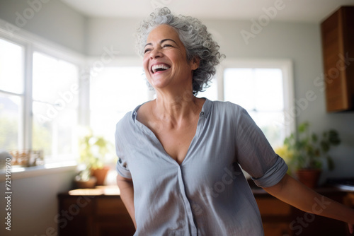 Hispanic middle aged mature woman dancing at home