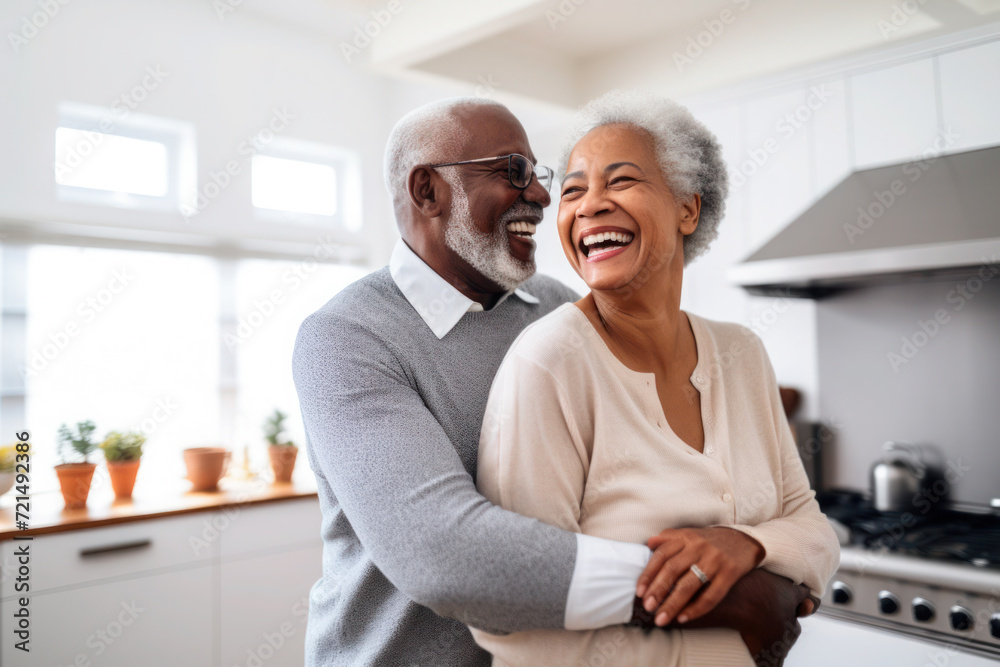 African multiracial married senior mature couple dancing in the kitchen African multiracial married senior mature couple dancing in the kitchen