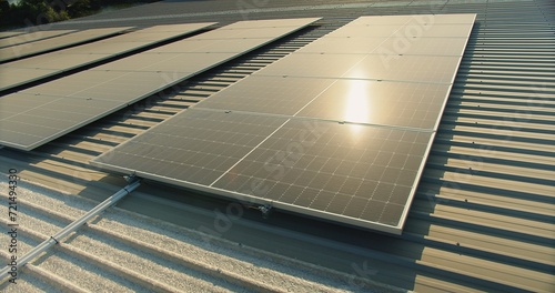 solar panels on a corrugated metal roof reflecting sunlight, showcasing alternative energy, Close-up of solar panels on an industrial building's roof capturing sunlight for energy.