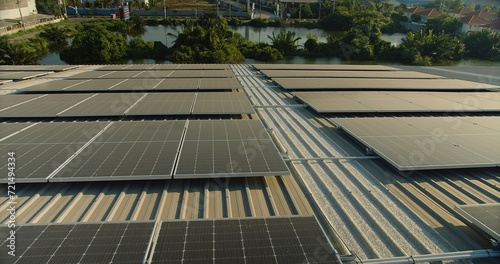 solar panels on a corrugated metal roof reflecting sunlight, showcasing alternative energy, Close-up of solar panels on an industrial building's roof capturing sunlight for energy.