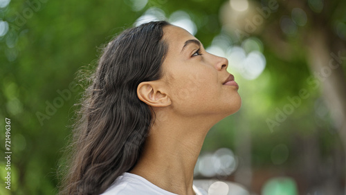 African american woman looking to the sky with serious expression at park photo