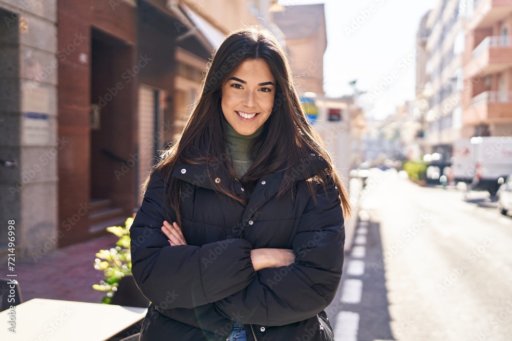 Young beautiful hispanic woman standing with arms crossed gesture at street Young beautiful hispanic woman standing with arms crossed gesture at street