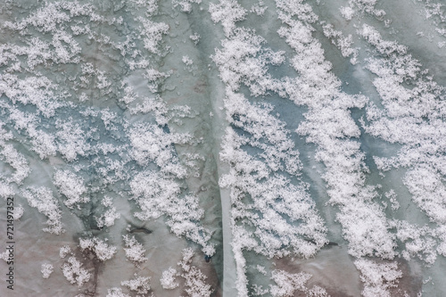 Background, texture of oilcloth with white snow on the surface. Photo, top view. photo