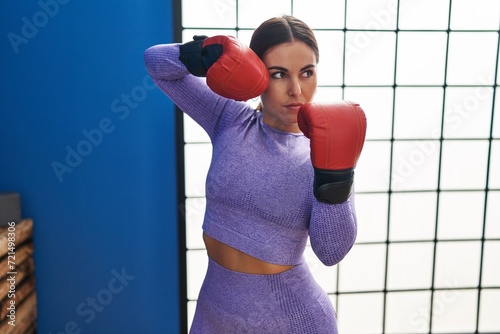 Young beautiful hispanic woman boxing at sport center © Krakenimages.com
