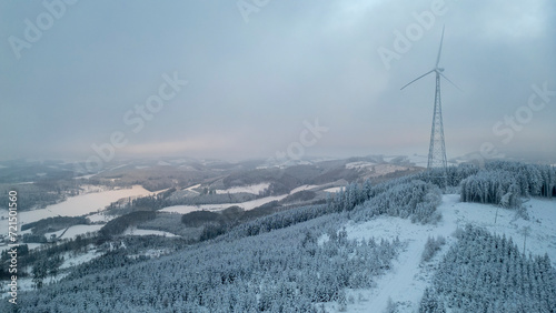 Windrad in verschneiter Landschaft im Sauerland photo