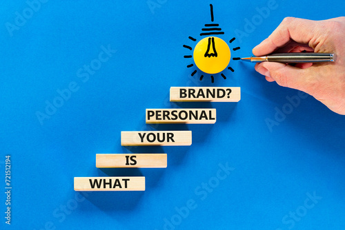 What is your personal brand symbol. Concept words What is your personal brand on wooden blocks. Beautiful blue background. Businessman hand. Business, what is your personal brand concept. Copy space.