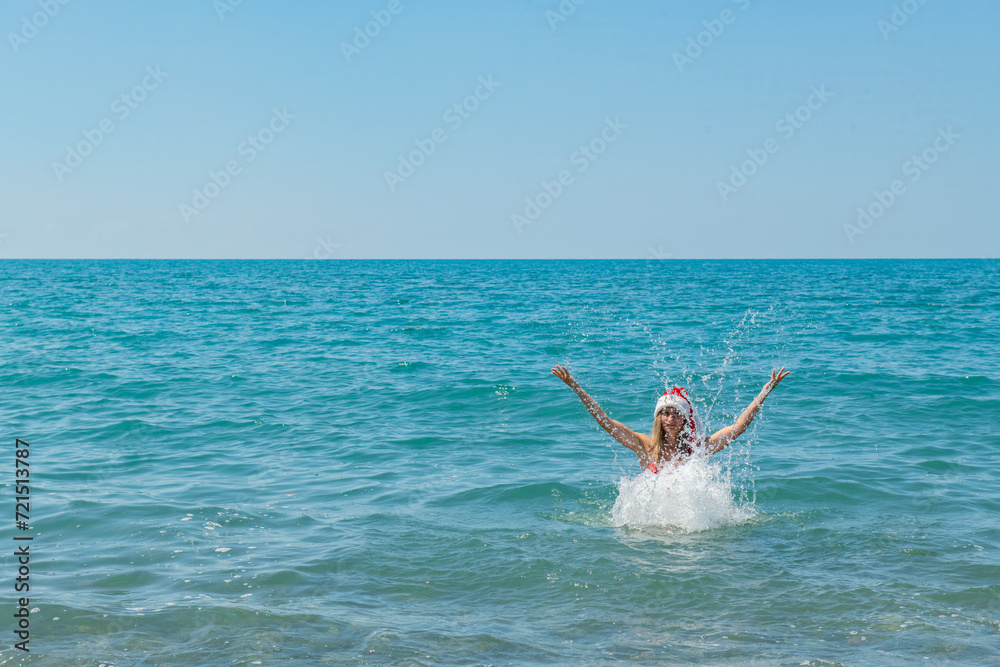 Beachside Santa Joy: Girl in Red Swimsuit and Santa Hat Beachside Santa Joy: Girl in Red Swimsuit and Santa Hat