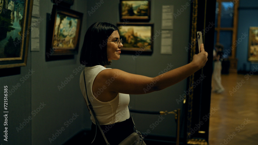 Young beautiful hispanic woman visiting art gallery taking selfie picture at Art Museum in Vienna Young beautiful hispanic woman visiting art gallery taking selfie picture at Art Museum in Vienna
