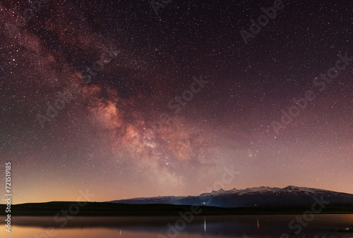 Beautiful night landscape   bright Milky Way galaxy on the lake.
