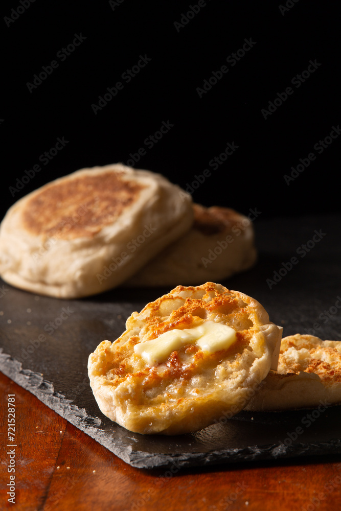 Buttered toasted English muffin dark background Buttered toasted English muffin dark background