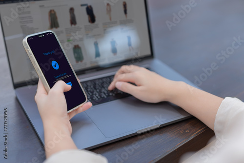 Online shopping concept, Woman hands holding using  smartphone making online payment with laptop