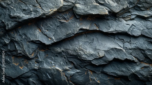 Black and grey rock surface with small cracks and brown veins © Adobe Contributor