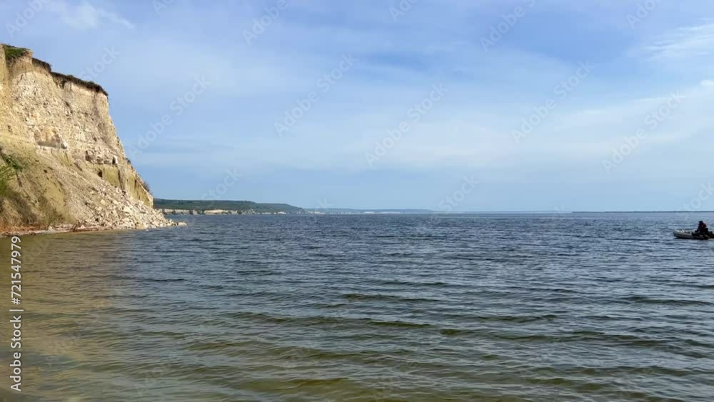 Beautiful summer view of Stepan Razin Rock on the Volga River, Saratov region, Russia. An amazing landscape with blue sky, steep cliffs and picturesque mountains with a white road. 4K Beautiful summer view of Stepan Razin Rock on the Volga River, Saratov region, Russia. An amazing landscape with blue sky, steep cliffs and picturesque mountains with a white road. 4K