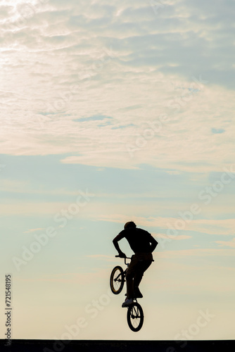 Freestyle cyclist practicing street BMX