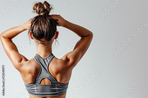 Back view of muscular bodybuilder on white background