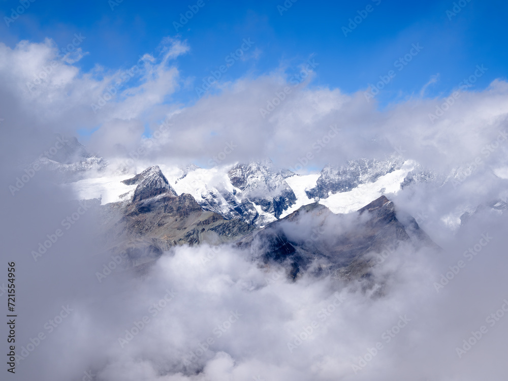 Idyllic view through the cloud at the swiss mountain landscape on the Gornergrat above Zermatt in the canton of Valais Idyllic view through the cloud at the swiss mountain landscape on the Gornergrat above Zermatt in the canton of Valais