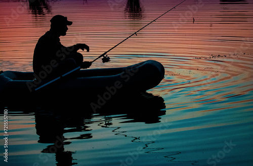 Mature man fishing on the lake from inflatable boa