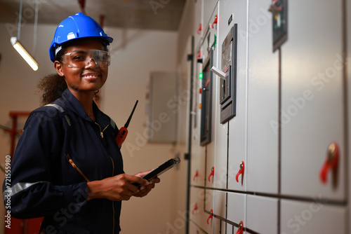 portrait smaile Female electrical engineer work at front of MDB main distribution board room, Internatonal Women's day , Women in Manufactory photo