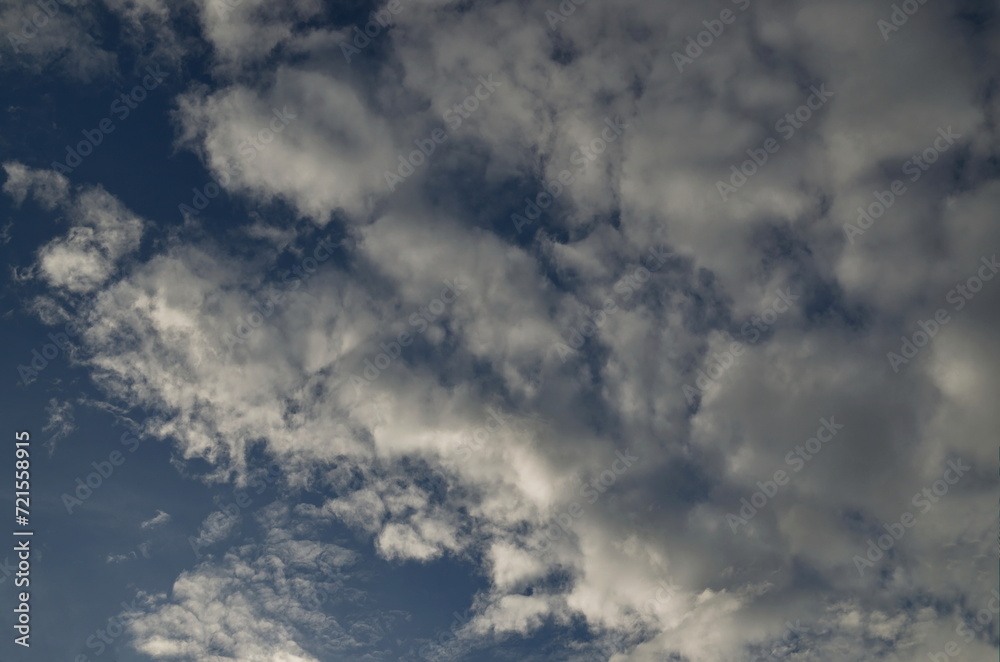 Background of rainy fluffy clouds floating on a bright blue sky, Sofia, Bulgaria  