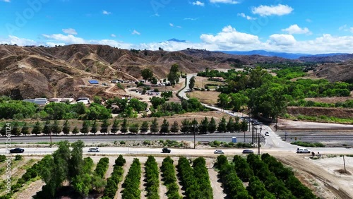 San Timoteo Canyon at the Train Rail Crossing with cars using the road near an Orange Grove in Redlands California photo