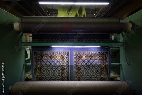 Modern Carpet weaving factory. Carpet making machine needle. Yarn bobbins attached to a carpet weaving machine. Inside Interior of a Fabric Weaving Factory.