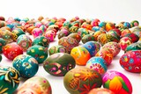 Lots of colourful Easter eggs on a white background.