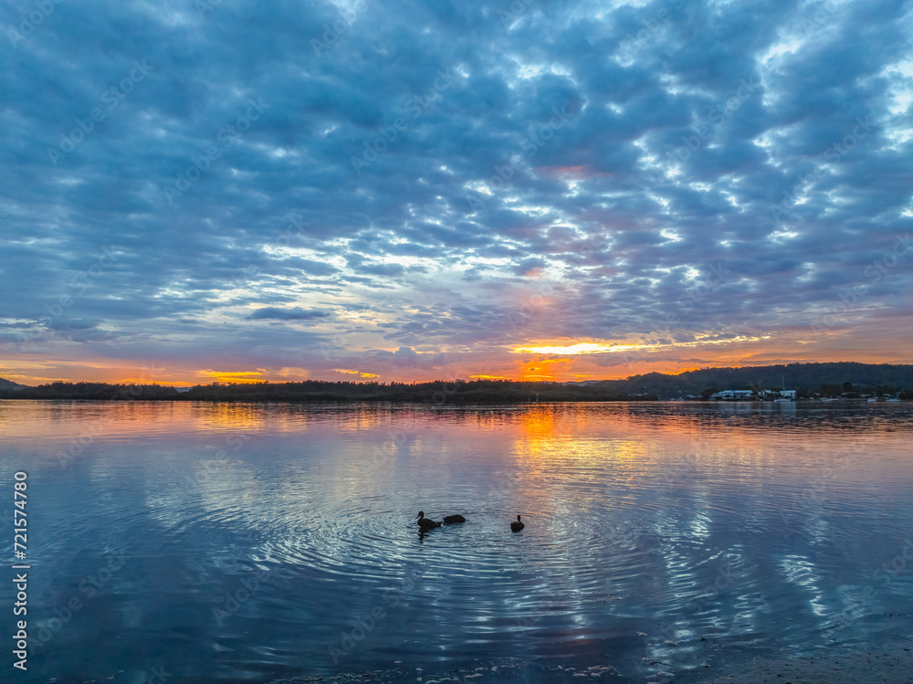 Fototapeta premium Sunrise over the bay water with clouds and reflections