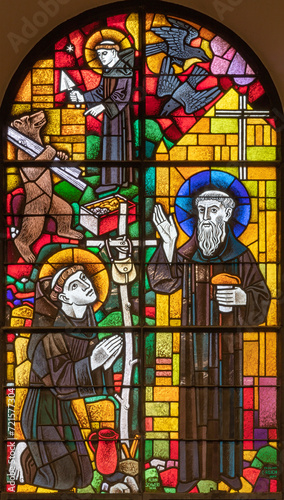 BERN, SWITZERLAND - JUNY 27, 2022: The and St. Gallus and St. Mainrad on the stained glass in the church Dreifaltigkeitskirche by A. Schweri (1938). photo