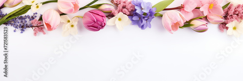 Beautiful spring banner with delicate flowers tulips, daffodils, lilacs, forget-me-nots on light background with copy space