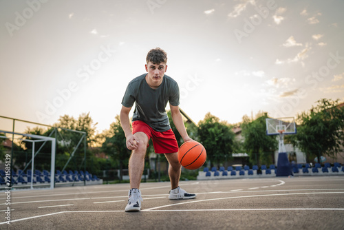 One caucasian teenager stand on basketball court with ball © Miljan Živković