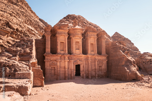Landscape - Ad Deir (the monastery), a monumental building carved out of rock in the ancient Jordanian city of Petra. bright sunlight with copy space in sky and sand