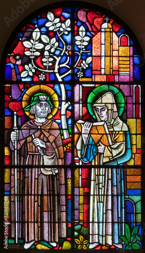 BERN, SWITZERLAND - JUNY 27, 2022: The St. Fridolin and St. Ulrich on the stained glass in the church Dreifaltigkeitskirche by A. Schweri (1938).