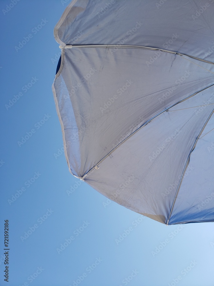 Summer blue sky on the beach with umbrella