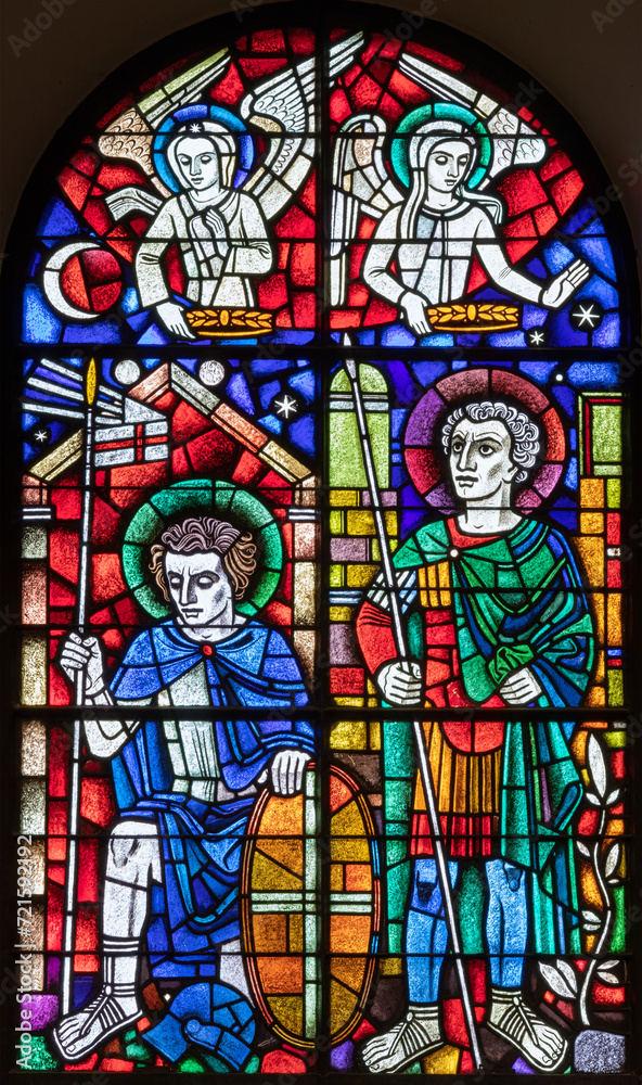 BERN, SWITZERLAND - JUNY 27, 2022: The St. Ursus of Solothurn and St. Victor on the stained glass in the church Dreifaltigkeitskirche by A. Schweri (1938).