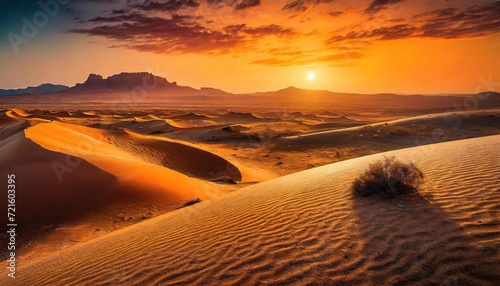 Sand dunes  desert with mountain ranges and sunset.