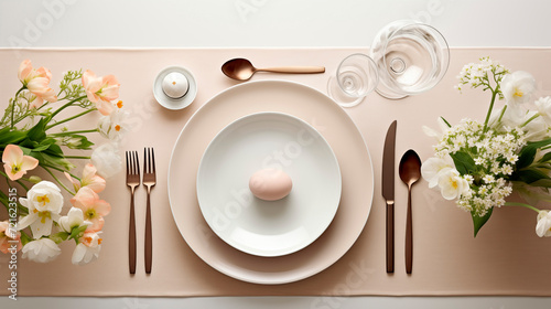 Beautiful Pastel table setting with eggs and spring flowers for Easter celebration.