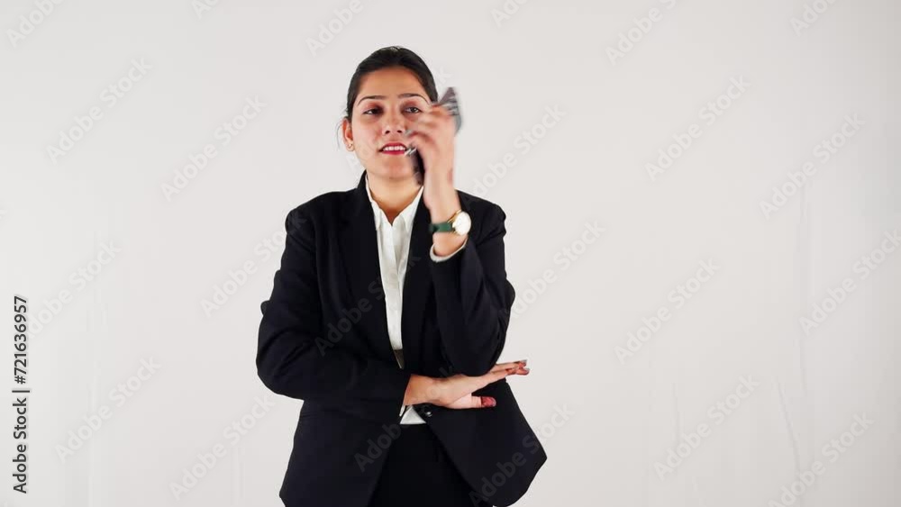Focused smiling business woman using smart phone taking call against a white background Focused smiling business woman using smart phone taking call against a white background