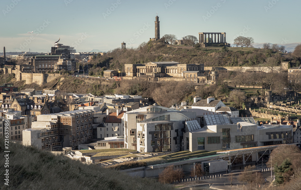 Aerial view of Calton Hill, Scottish Parliament Building with the skyline seen from the top of Salisbury Crags. Amazing Edinburgh cityscape, Destinations in Europe, Copy space, Selective focus.