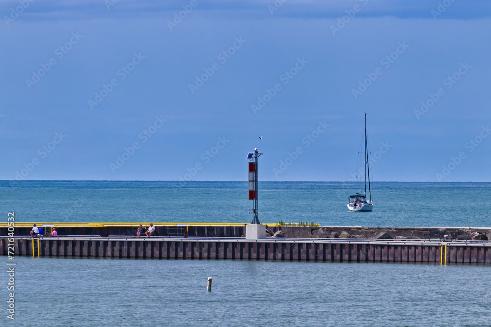 Relaxing summer day at the pier, solar powered lighthouse for recreation - scenes from Bayfield, Huron County, ON, Canada