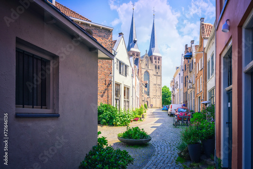 Fototapeta Naklejka Na Ścianę i Meble -  an image of a narrow street with lots of tall buildings