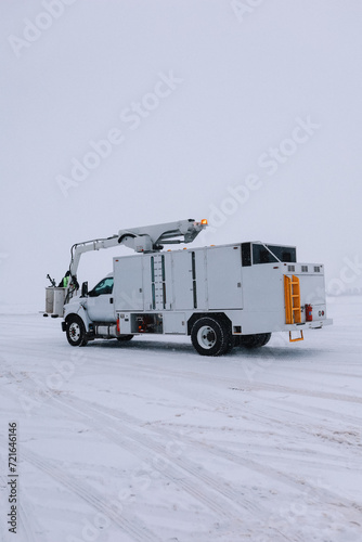 De-icing Truck with special equipment in a snowy airport