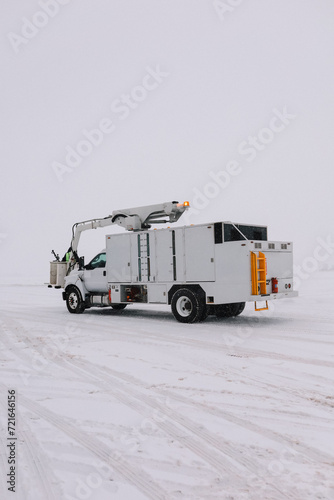 Aircraft deicer on the runway at a snowy airport