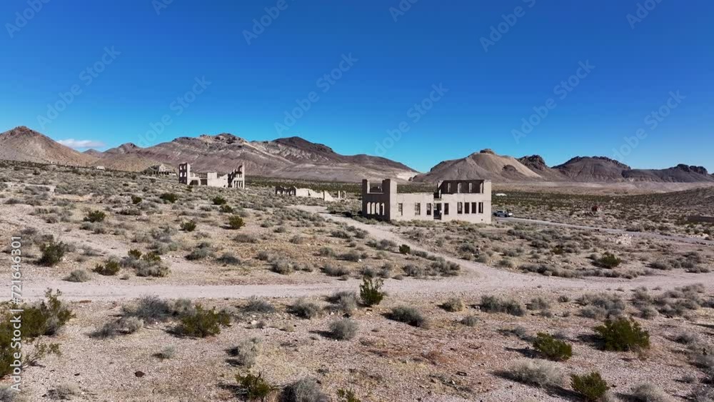 Aerial historic Rhyolite Ghost Town Nevada ruins fast. Near Death Valley National Park in California and Beatty Nevada. 1905 gold rush, 1911 a ghost town. Ruins of banks, school, train station. Aerial historic Rhyolite Ghost Town Nevada ruins fast. Near Death Valley National Park in California and Beatty Nevada. 1905 gold rush, 1911 a ghost town. Ruins of banks, school, train station.