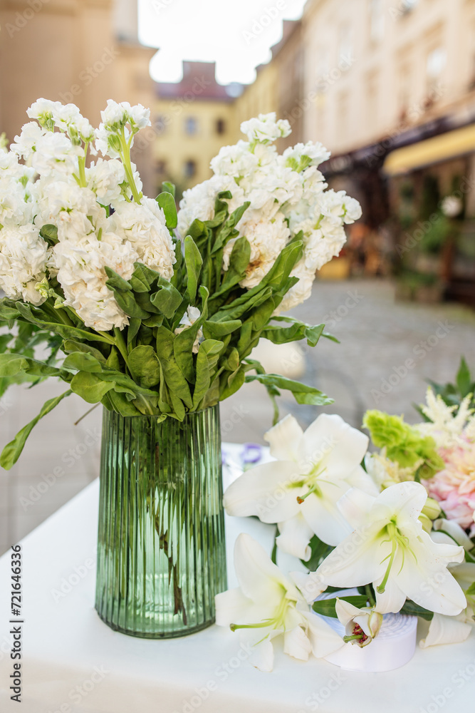 Floral decor for events. Vase of White Hydrangeas with Lilies on Display. Background