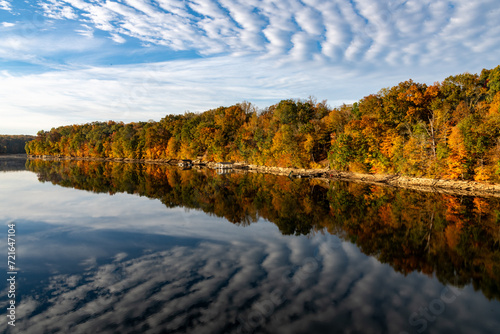 Fall Foliage Lake Reflection with distinctive cloud pattern on Caney Fork River at Rock Island State Park, TN.