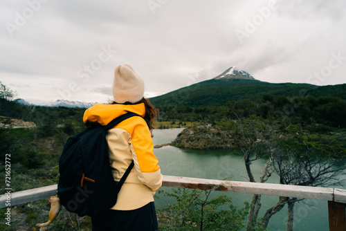 tourist in Bahia Lapataia amidst mountains at Tierra del Fuego photo
